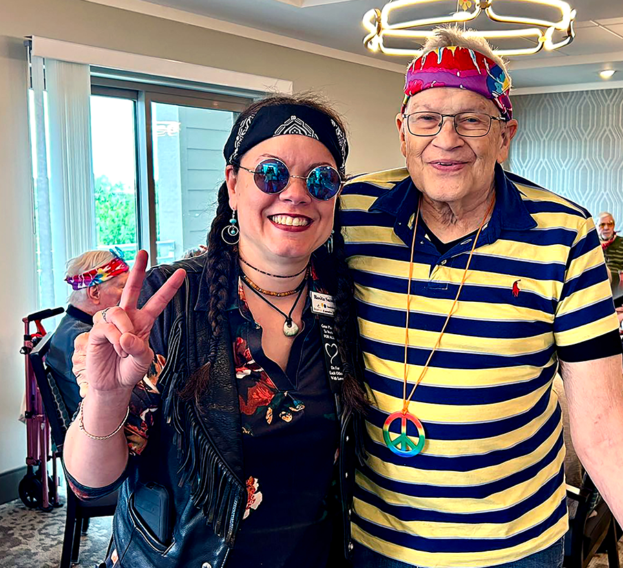 An employee with a resident smiling having fun