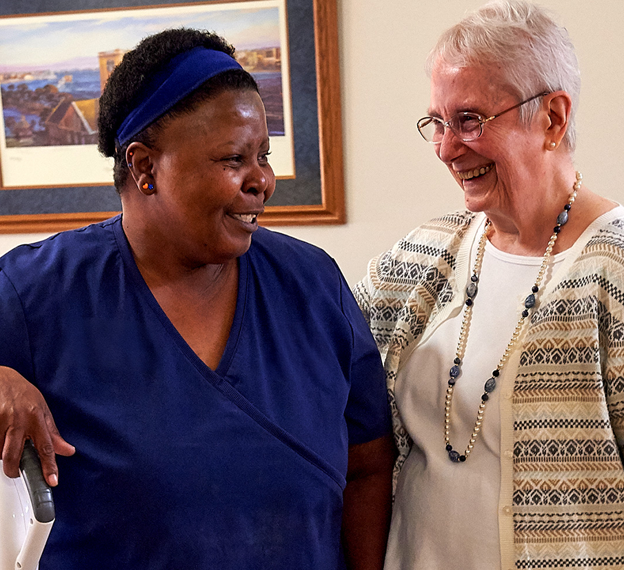 Resident and senior smiling at each other