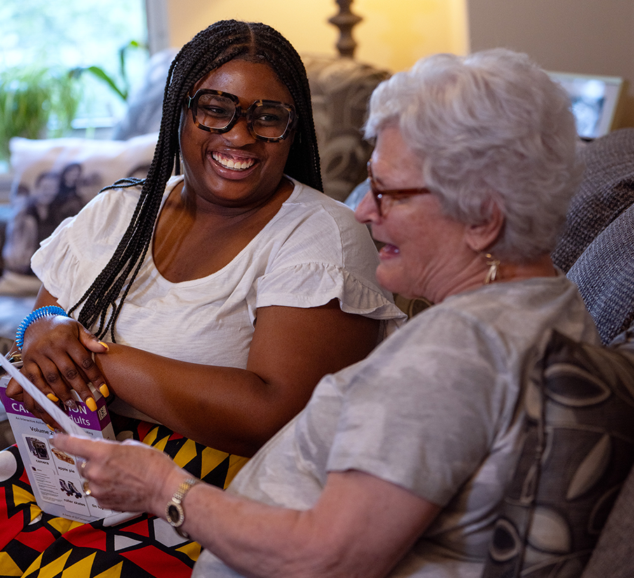 resident and employee smiling at each other
